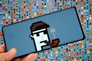 a smartphone with the image of a cartoon smoking a pipe on the screen