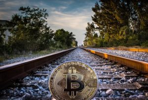 a bitcoin on train tracks