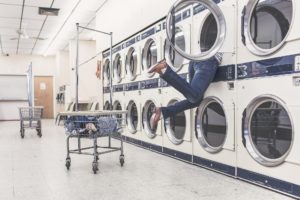 a person flailing out of a washing machine