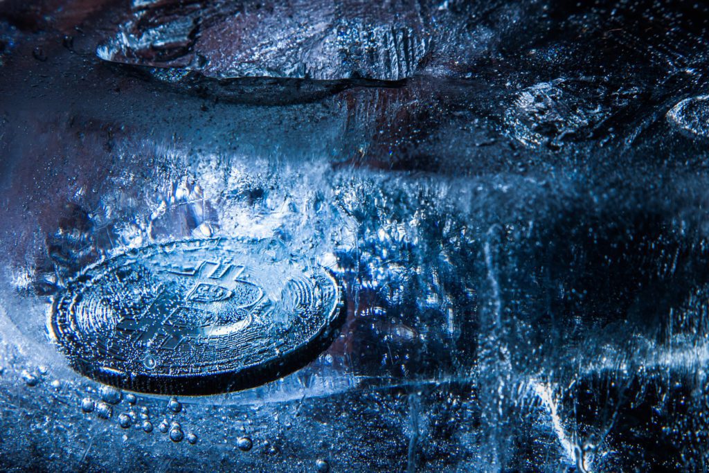 Silver Bitcoin token on ice