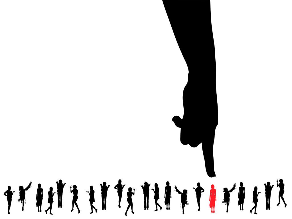 finger pointing at silhouette in group of black silhouettes