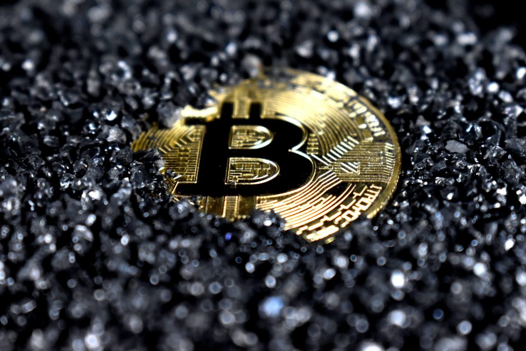 Bitcoin token surrounded by black diamonds